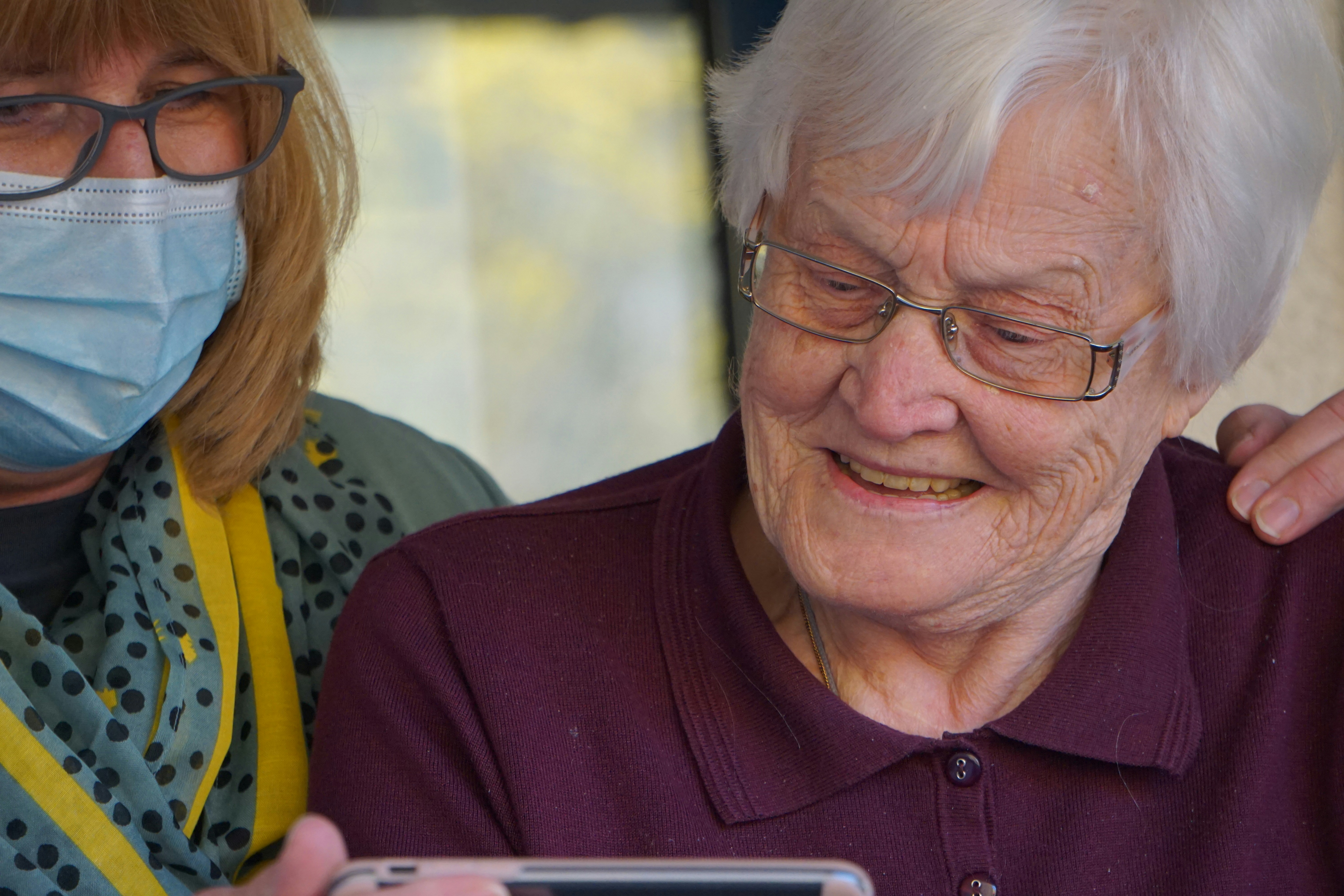 Two senior women with caring support